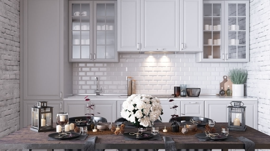 Mẫu tủ bếp 18 | Nội Thất SHC Tủ bếp trắng có cánh kính, tường gạch trắng và bàn ăn gỗ phía trước